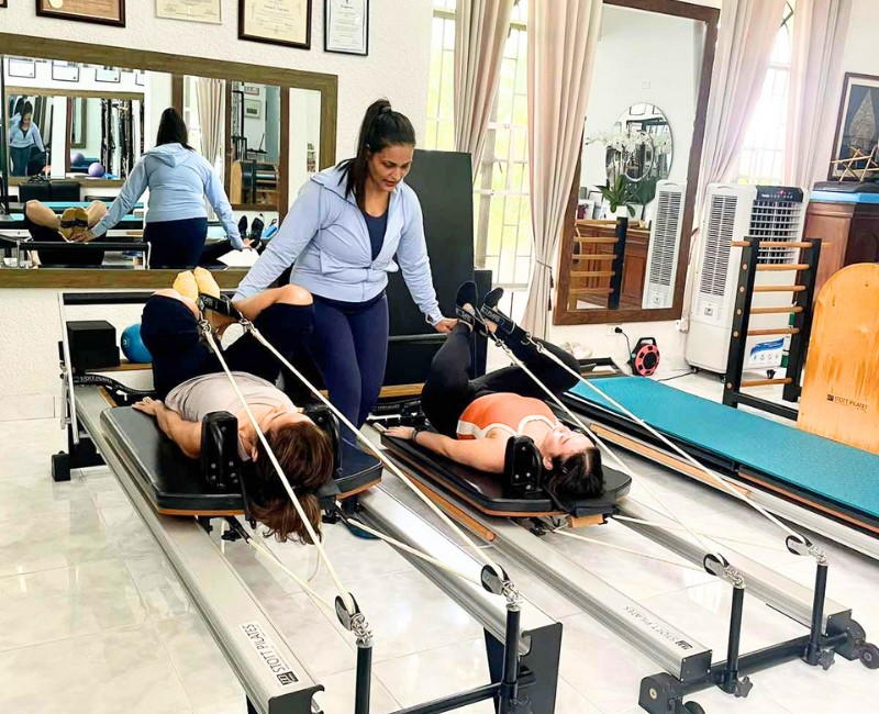 Duet pilates workout and stability chair exercises with partner at Essenzaa Pilates