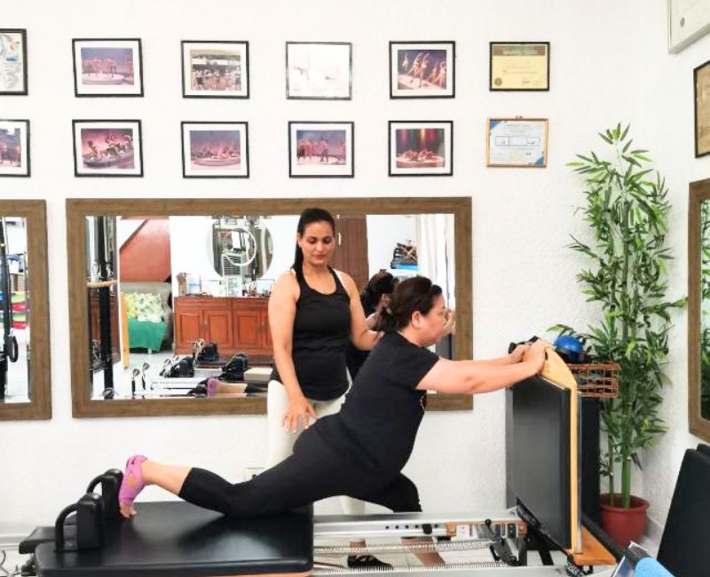 Private 1 on 1 pilates session with personal trainer on barrel at Essenzaa Pilates